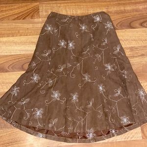 Brown mid-length skirt with white flower detailing